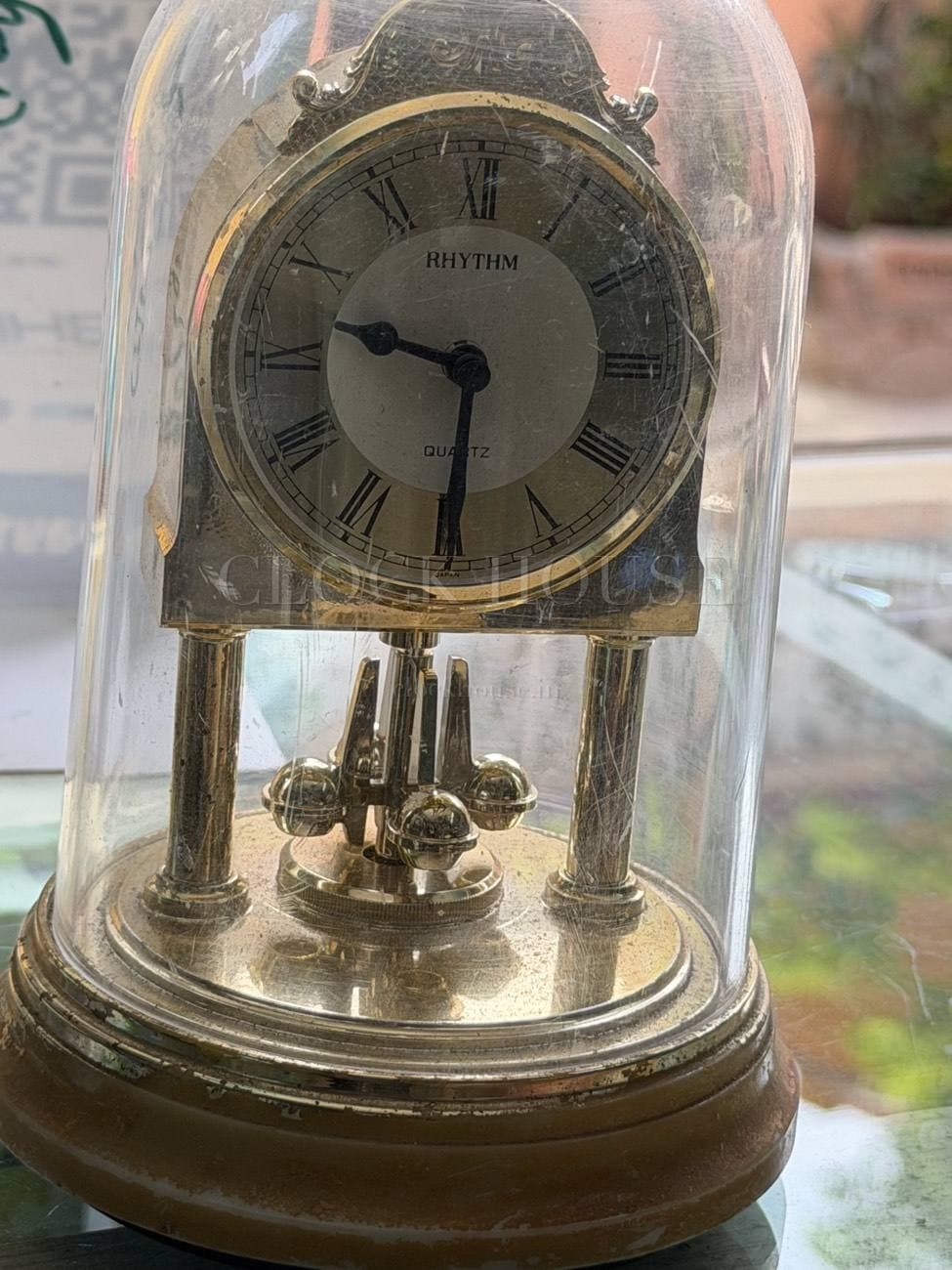 Rhythm quartz anniversary clock under a glass dome at Clock House