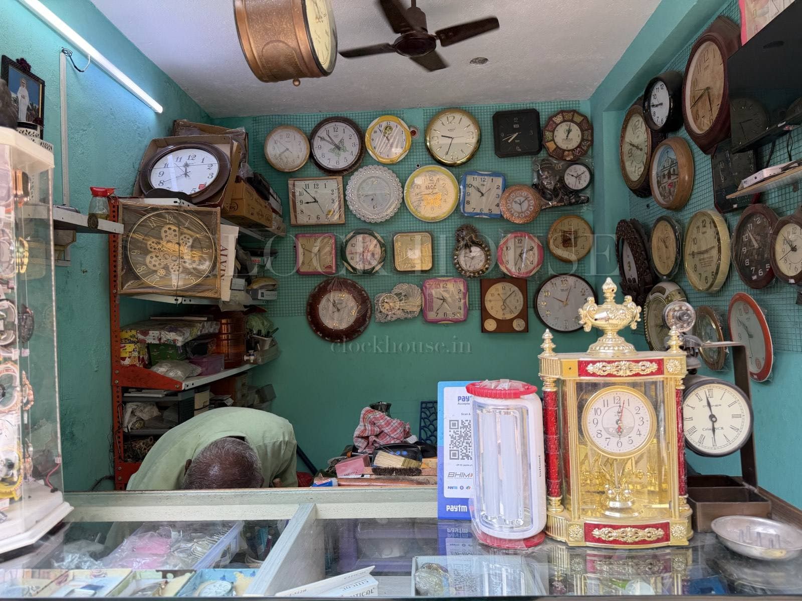 Inside Clock House: a wall of clocks above the watch counter