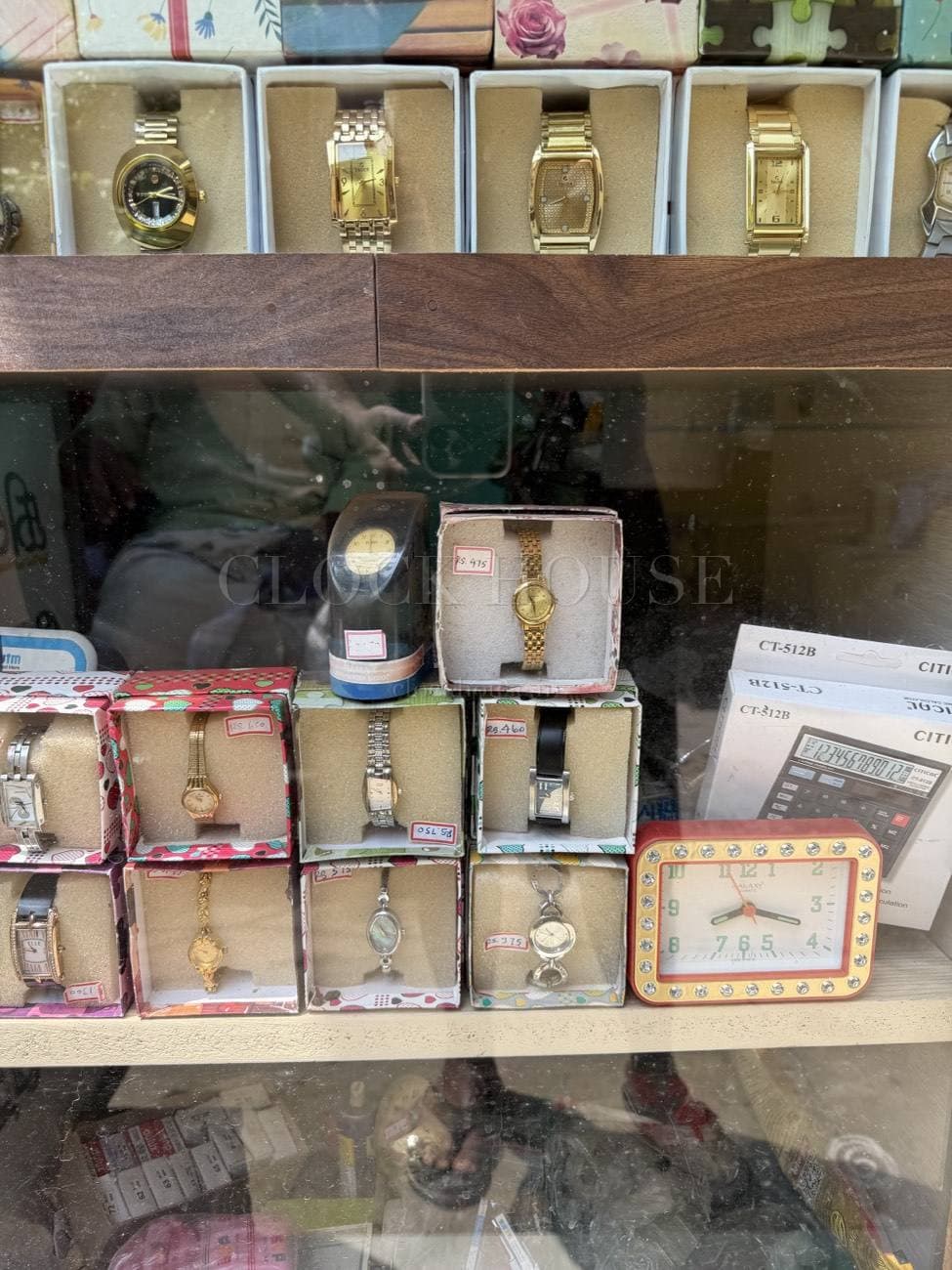 Gold-tone watches and a vintage table clock at Clock House